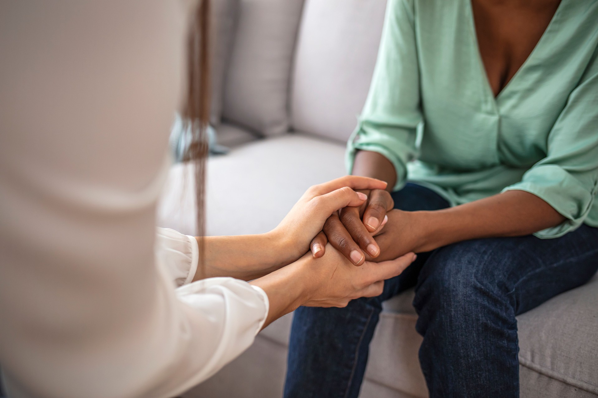 African psychologist hold hands of girl patient, close up.